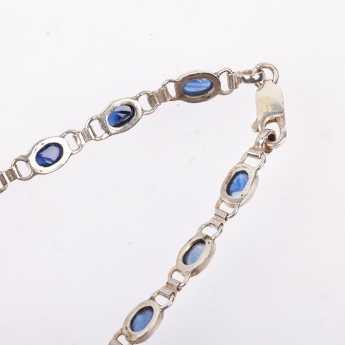 1454 - A modern sterling silver sapphire tennis line bracelet, set with oval cabochon sapphires, 20.5cm, 8.... 