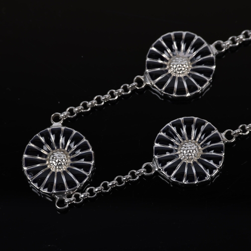 1472 - GEORG JENSEN - a modern Danish sterling silver and black enamel daisy pattern bracelet, designed by ... 