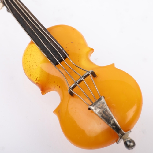 1518 - An Antique novelty amber violin brooch, with unmarked silver settings, 75.5mm, 10g