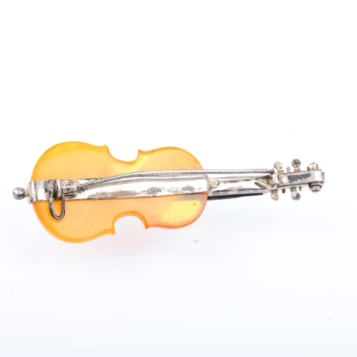 1518 - An Antique novelty amber violin brooch, with unmarked silver settings, 75.5mm, 10g