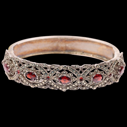 1520 - A mid-20th century silver garnet and marcasite hinged bangle, maker NCR Co, Birmingham 1958, band wi... 