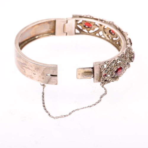 1520 - A mid-20th century silver garnet and marcasite hinged bangle, maker NCR Co, Birmingham 1958, band wi... 