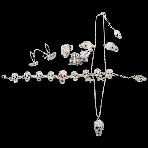 1575 - BUTLER & WILSON - a Vintage rhinestone skull jewellery set, comprising necklace, bracelet and 3 ring... 