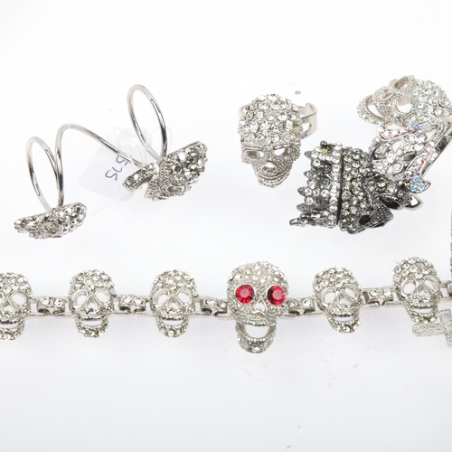 1575 - BUTLER & WILSON - a Vintage rhinestone skull jewellery set, comprising necklace, bracelet and 3 ring... 