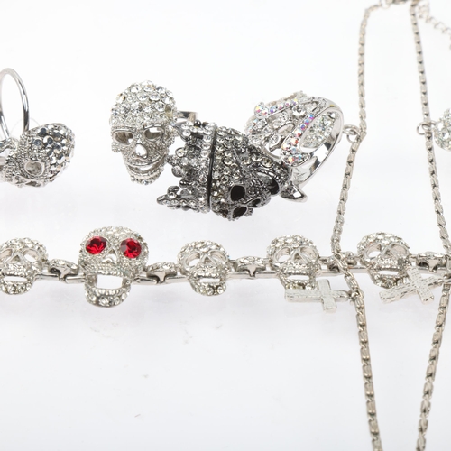 1575 - BUTLER & WILSON - a Vintage rhinestone skull jewellery set, comprising necklace, bracelet and 3 ring... 