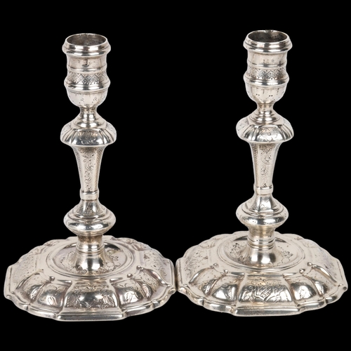 1668 - A pair of George II silver table candlesticks, Joseph Bird, London 1732, bright-cut engraved decorat... 