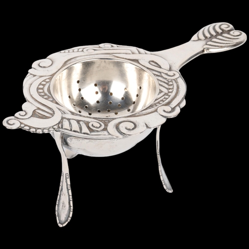 1675 - An Art Nouveau Danish silver tea strainer and stand, circa 1917 and 1920, strainer 13cm, stand heigh... 