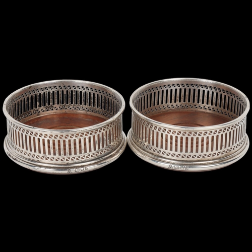 1712 - A pair of Elizabeth II silver-mounted oak wine bottle coasters, MC Hersey & Son Ltd, London 1982, in... 