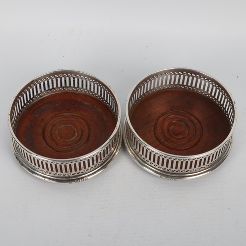 1712 - A pair of Elizabeth II silver-mounted oak wine bottle coasters, MC Hersey & Son Ltd, London 1982, in... 