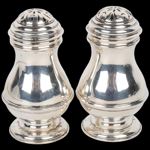 1713 - A pair of George VI silver bun pepperettes, Harman & Co, London 1937, in George II style, pedestal b... 