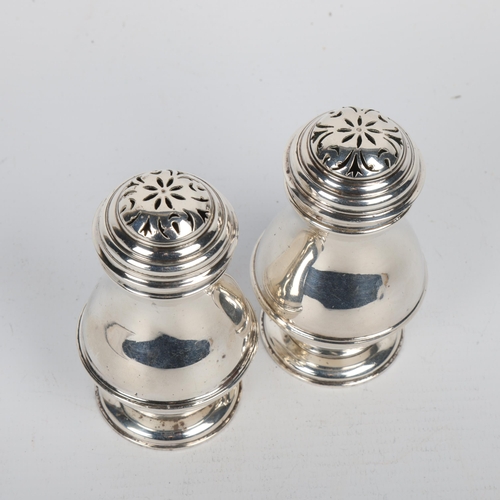 1713 - A pair of George VI silver bun pepperettes, Harman & Co, London 1937, in George II style, pedestal b... 