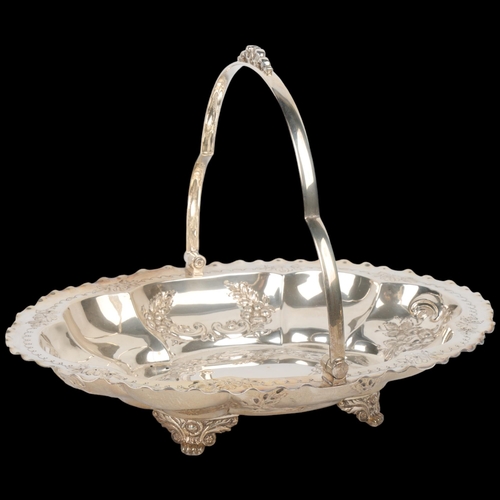 1720 - An Edwardian silver swing-handled cake basket, A Willis & Co, Sheffield 1904, oval lobed form with c... 