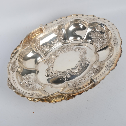 1720 - An Edwardian silver swing-handled cake basket, A Willis & Co, Sheffield 1904, oval lobed form with c... 