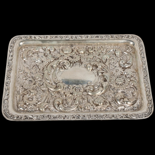 1724 - An Edwardian silver dressing table tray, Walker & Hall, Sheffield 1904, allover high relief embossed... 