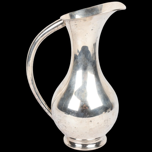 1732 - A large Japanese silver ewer, circa 1940, signed on base, baluster form with large tapered handle an... 