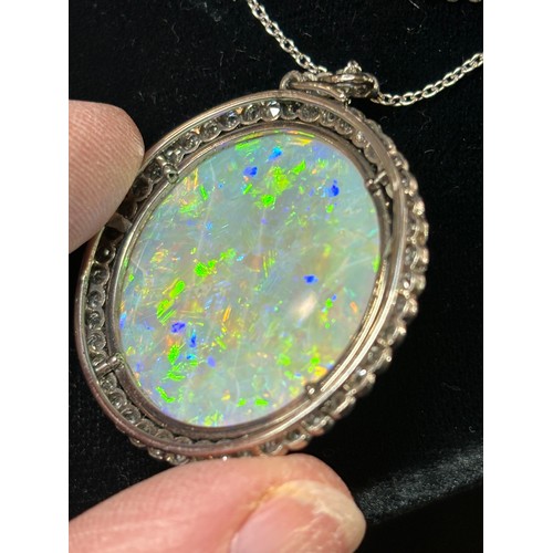 1125 - A Belle Epoque opal and diamond cluster pendant necklace, rub-over set with 15ct round cabochon opal... 