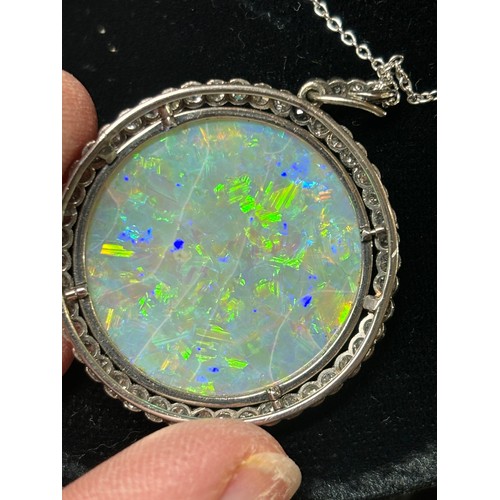 1125 - A Belle Epoque opal and diamond cluster pendant necklace, rub-over set with 15ct round cabochon opal... 