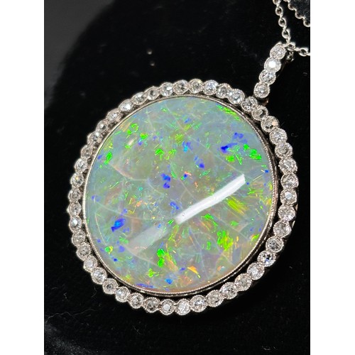 1125 - A Belle Epoque opal and diamond cluster pendant necklace, rub-over set with 15ct round cabochon opal... 