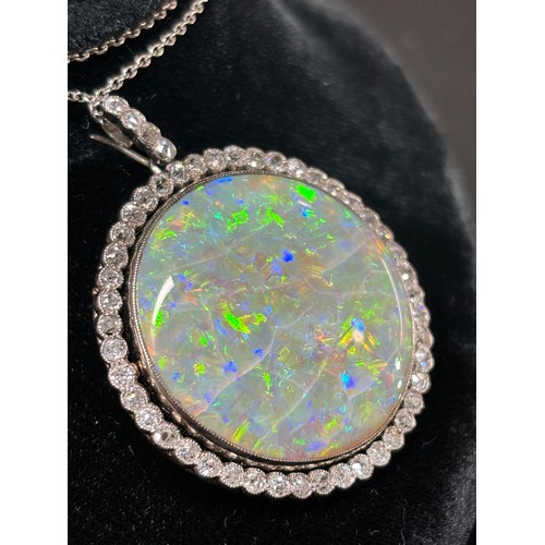 1125 - A Belle Epoque opal and diamond cluster pendant necklace, rub-over set with 15ct round cabochon opal... 