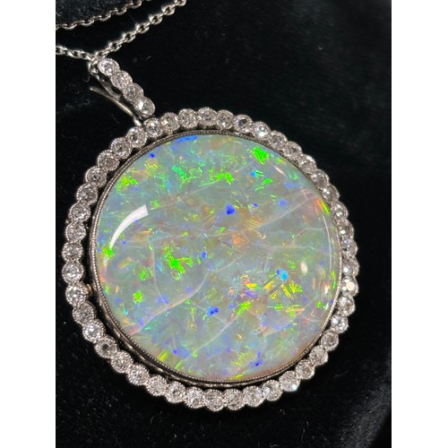 1125 - A Belle Epoque opal and diamond cluster pendant necklace, rub-over set with 15ct round cabochon opal... 