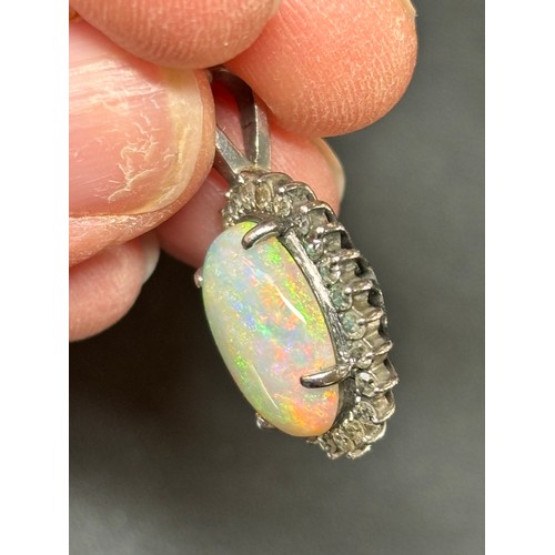 1148 - A late 20th century opal and diamond oval cluster pendant, claw set with 3ct oval cabochon opal surr... 