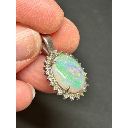 1148 - A late 20th century opal and diamond oval cluster pendant, claw set with 3ct oval cabochon opal surr... 