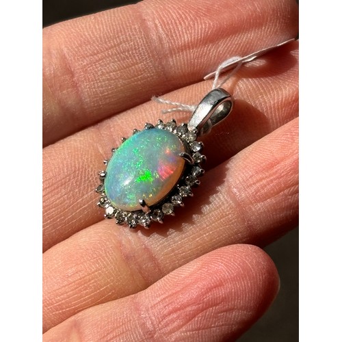 1148 - A late 20th century opal and diamond oval cluster pendant, claw set with 3ct oval cabochon opal surr... 