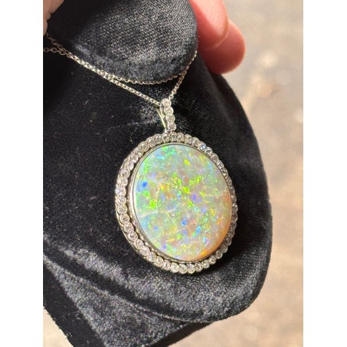 1125 - A Belle Epoque opal and diamond cluster pendant necklace, rub-over set with 15ct round cabochon opal... 