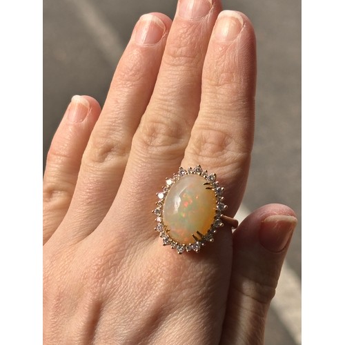 1171 - An impressive 18ct gold Ethiopian opal and diamond oval cluster ring, centrally double claw set with... 