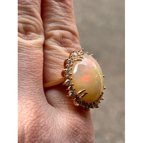 1171 - An impressive 18ct gold Ethiopian opal and diamond oval cluster ring, centrally double claw set with... 