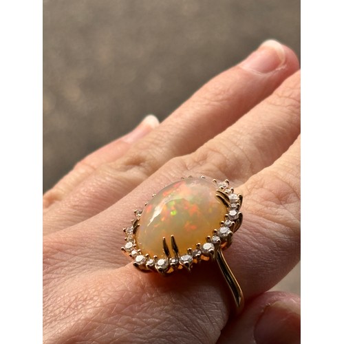 1171 - An impressive 18ct gold Ethiopian opal and diamond oval cluster ring, centrally double claw set with... 