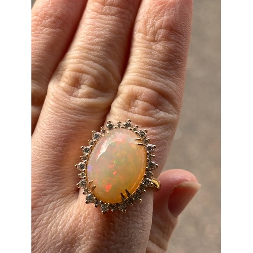 1171 - An impressive 18ct gold Ethiopian opal and diamond oval cluster ring, centrally double claw set with... 