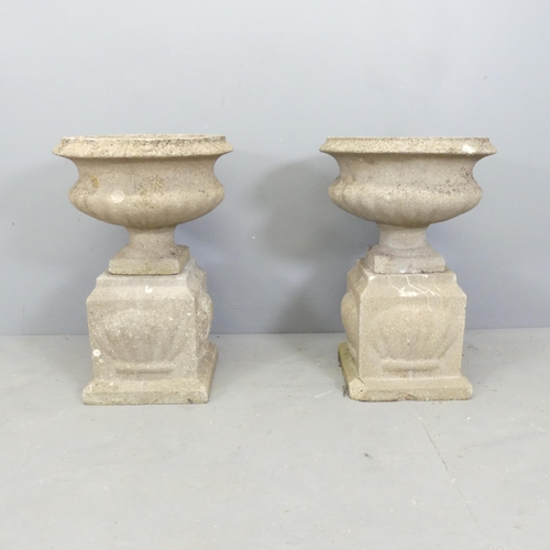 75 - A pair of weathered concrete garden urns on plinth bases. Overall 45x66cm.