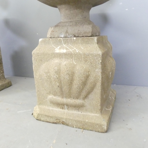 75 - A pair of weathered concrete garden urns on plinth bases. Overall 45x66cm.