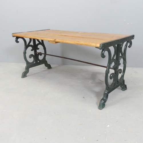 76 - A slatted pine low table / bench with painted cast iron ends. 88x40x44cm.