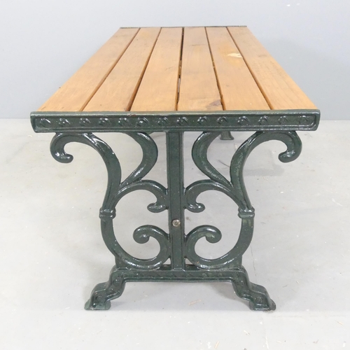 76 - A slatted pine low table / bench with painted cast iron ends. 88x40x44cm.