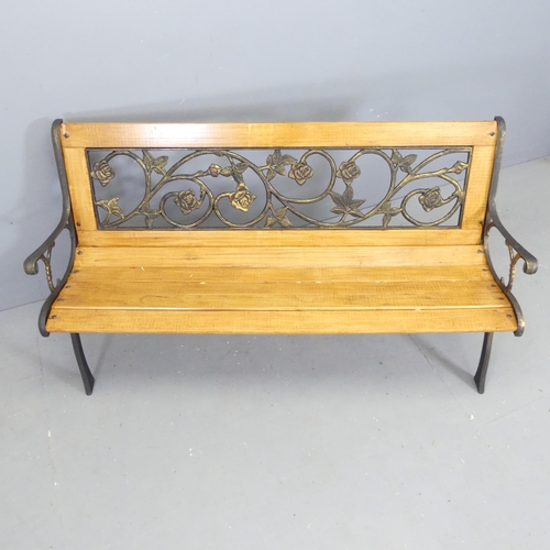 89 - A modern pine slatted garden bench, with cast metal ends and inset gilded metal floral design back. ... 