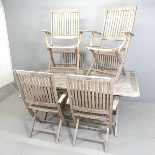 90 - A weathered teak folding garden table, 160x74x100cm, and six matching folding chairs. All labelled f... 