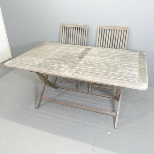 90 - A weathered teak folding garden table, 160x74x100cm, and six matching folding chairs. All labelled f... 