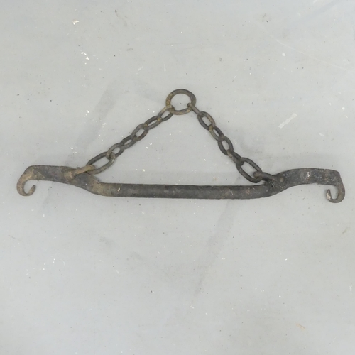 95 - An Eastern cast iron pot carrier. Length 84cm.