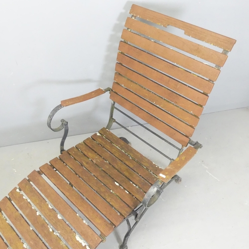 97 - A vintage teak slatted steamer lounge chair on folding iron base.