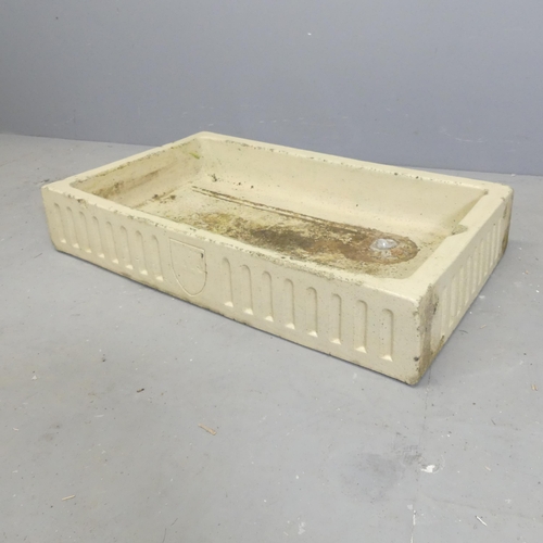 104 - A glazed rectangular stone butler's sink, with fluted and armorial decoration.