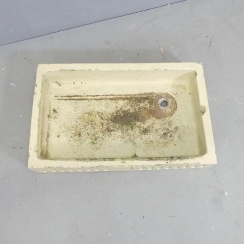 104 - A glazed rectangular stone butler's sink, with fluted and armorial decoration.