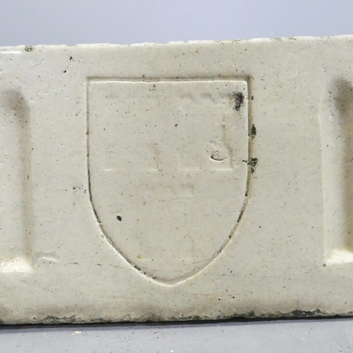 104 - A glazed rectangular stone butler's sink, with fluted and armorial decoration.