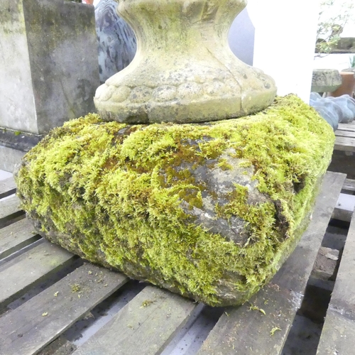 119 - A large and impressive swag nosed urn on weathered stone plinth base. 67x102cm.