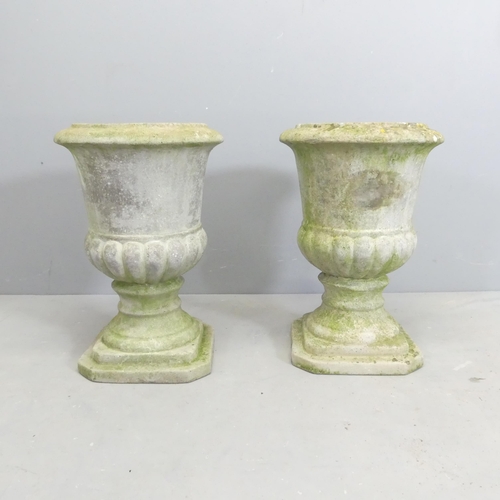 122 - A pair of weathered concrete garden urns. 32x46cm.