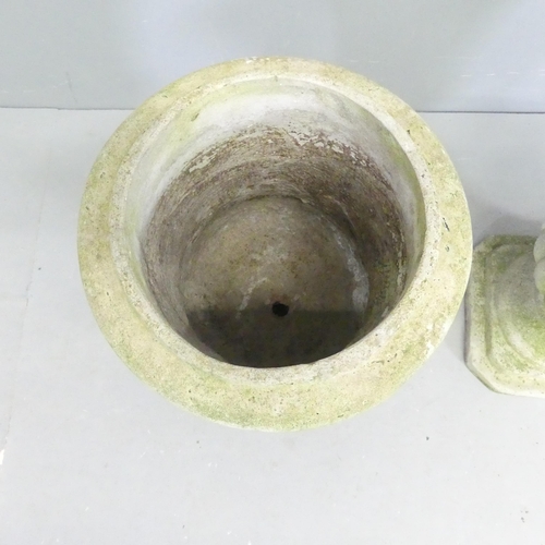 122 - A pair of weathered concrete garden urns. 32x46cm.