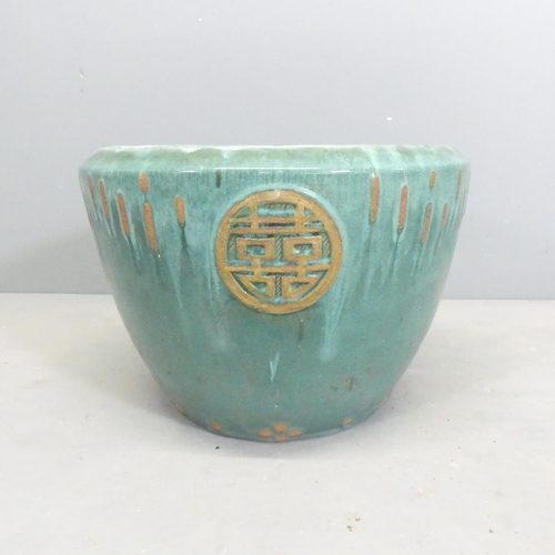 123 - A glazed terracotta garden pot with Chinese design. 40x29cm.