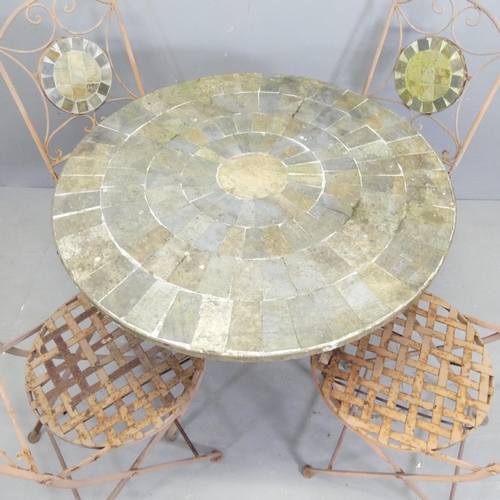 125 - A circular slate mosaic topped garden table on wrought metal base, 80x71cm, with four matching foldi... 