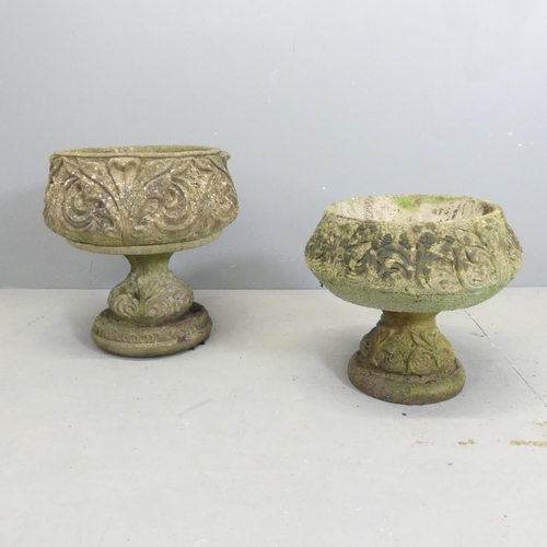 127 - Two similar weathered concrete garden urns on stands, with acanthus leaf decoration. Largest 45x48cm... 